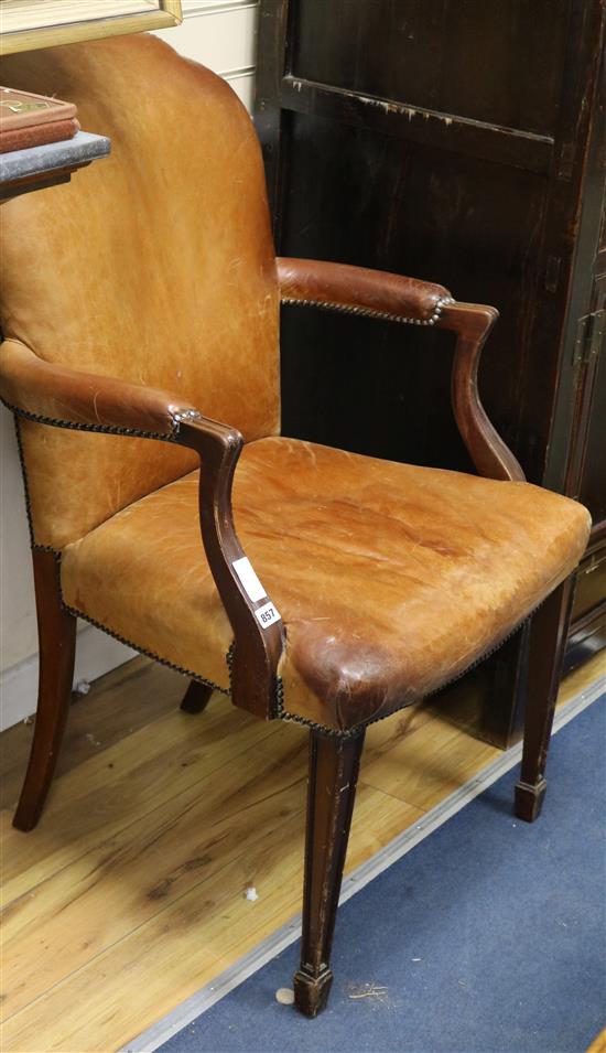 A leather upholstered elbow chair